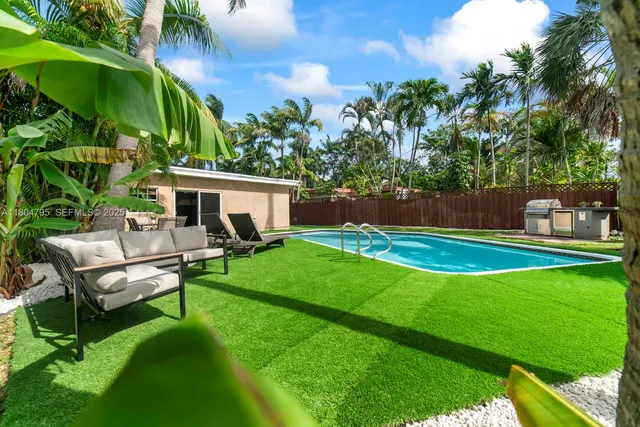 a view of house with backyard and a patio