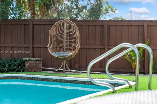 a view of swimming pool with a backyard and stairs