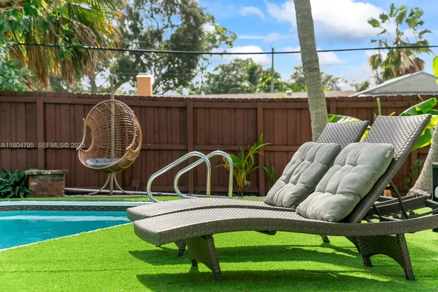 a front view of a house with garden and sitting area