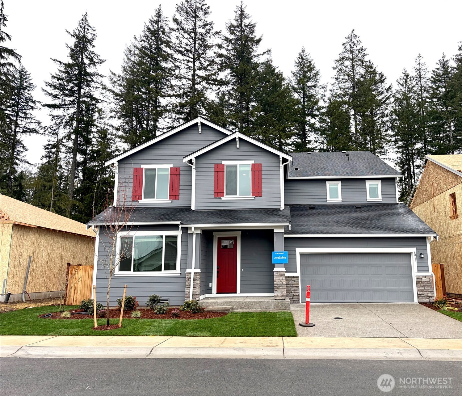 6094 Trce Drive Southwest Port Orchard, WA 98367 - Photo 1 of 33 a front view of a house with a garden and trees