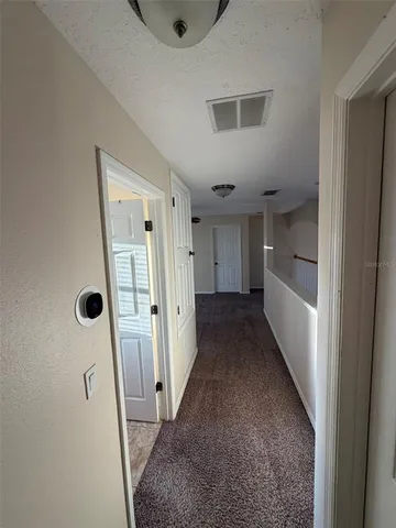 a view of a hallway to rooms