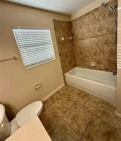 a bathroom with a toilet and a bathtub