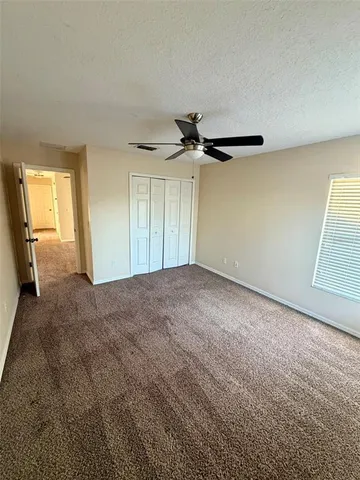 a view of a room with a ceiling fan