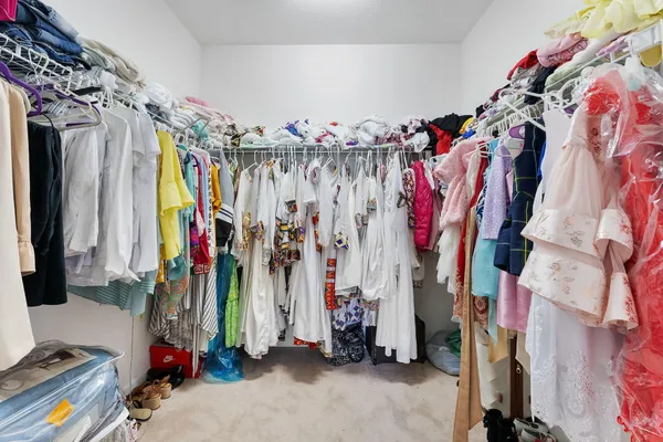 an aerial view of a city with lots of residential buildings ocean and mountain view in back