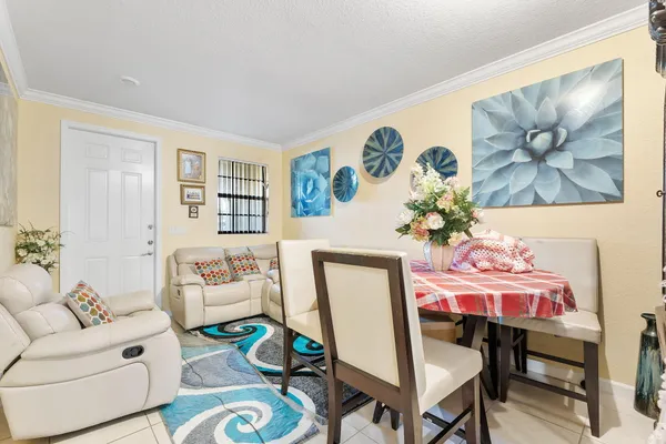 a kitchen with stainless steel appliances granite countertop a stove top oven a sink dishwasher and white cabinets with wooden floor