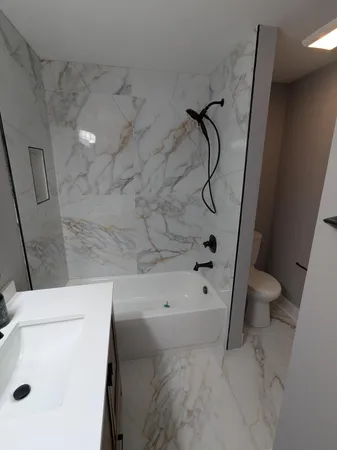 a bathroom with a sink a toilet and a shower
