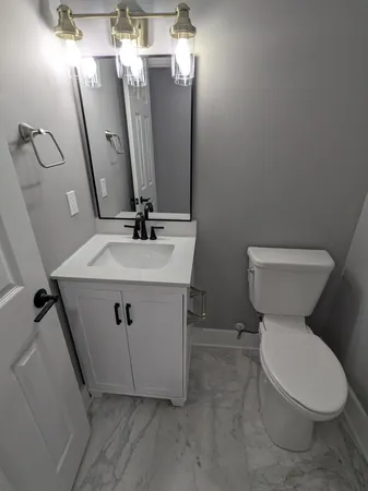 a view of bathroom with a toilet sink and mirror