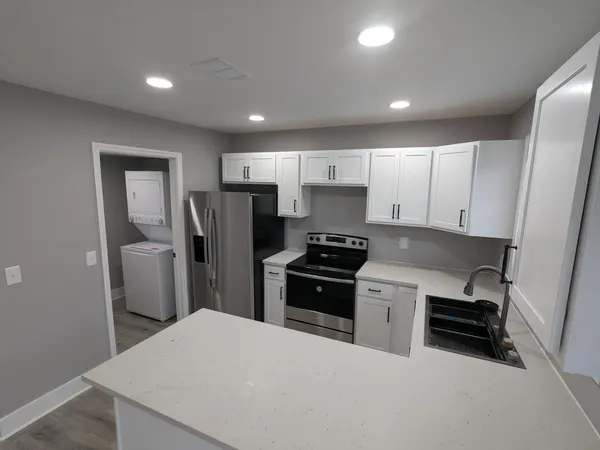 a kitchen with stainless steel appliances a refrigerator stove microwave and sink