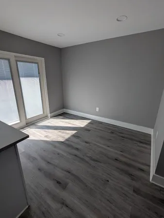 a view of wooden floor and windows in a room