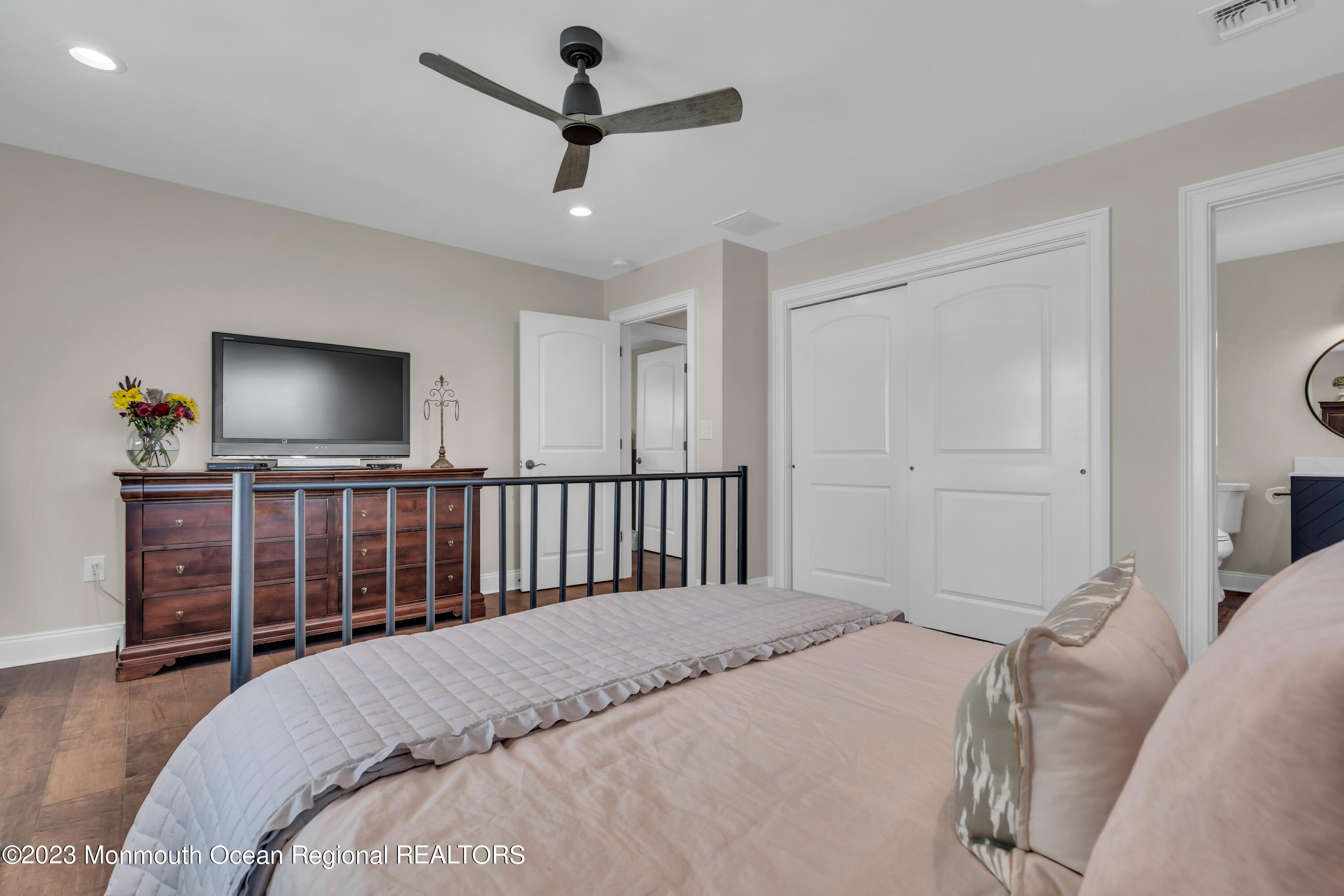 2118 Edgewood Place, Unit JULY Spring Lake, NJ 07762 - Photo 38 of 61 a bedroom with a large bed and a flat screen tv