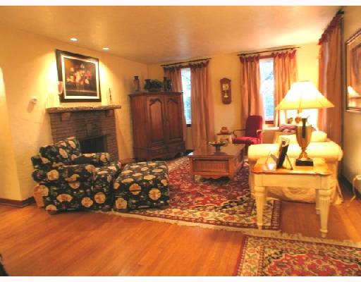 1174 Prospect Road Whitehall, PA 15227 - Photo 2 of 8 Living Room. Hardwood Floors, Accent Lights above Log Burning Fireplace