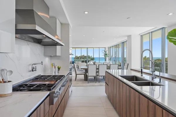 a kitchen with stainless steel appliances granite countertop a stove a sink and a refrigerator