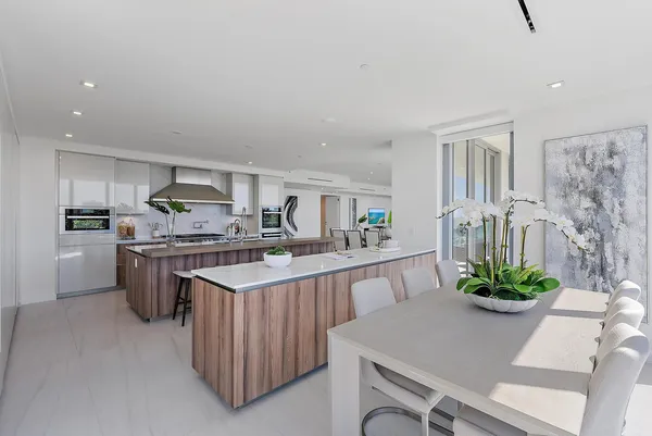 a kitchen with stainless steel appliances granite countertop a refrigerator a stove and a sink