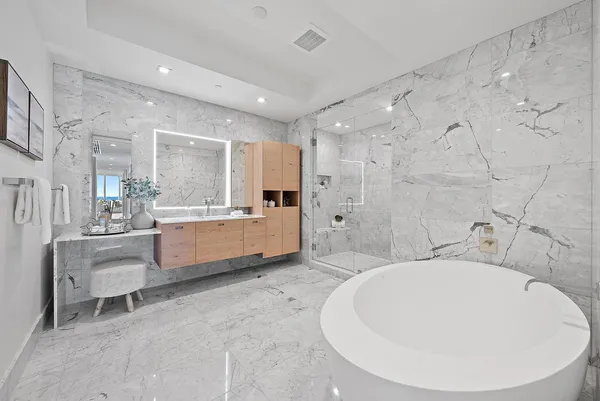 a bathroom with a sink mirror and a bathtub
