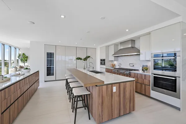 a kitchen with stainless steel appliances kitchen island a stove and a refrigerator