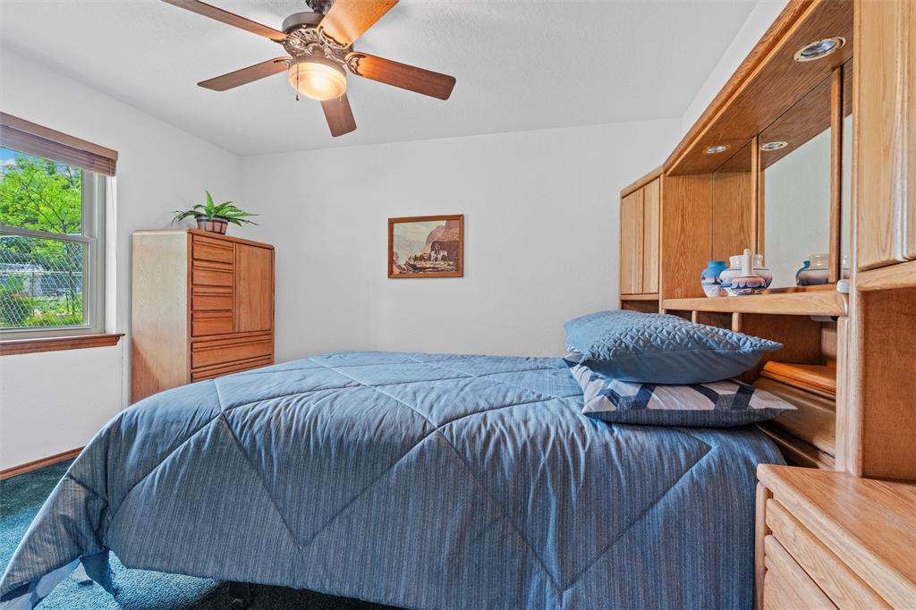 217 Valley Ranch Road Weatherford, TX 76087 - Photo 28 of 38 Bedroom featuring carpet flooring and a ceiling fan with integrated lighting