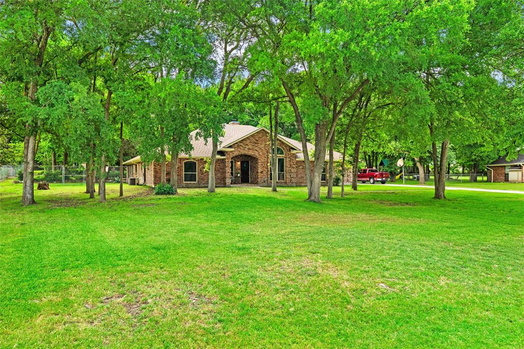 217 Valley Ranch Road Weatherford, TX 76087 - Photo 3 of 38 Brick exterior residence situated on a spacious green lot with mature trees