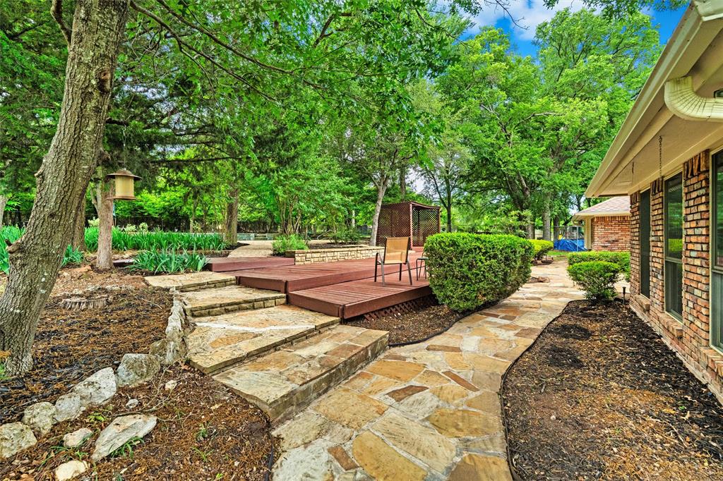 217 Valley Ranch Road Weatherford, TX 76087 - Photo 33 of 38 Stone pathway leading to a multi-tiered wood-finish deck