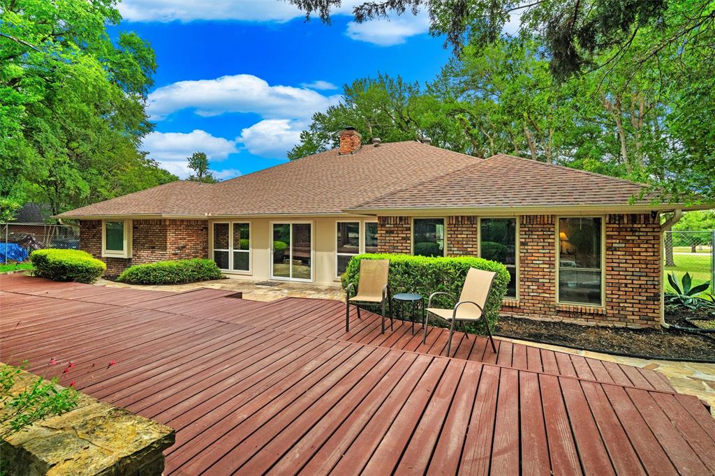217 Valley Ranch Road Weatherford, TX 76087 - Photo 34 of 38 Expansive wood-finish deck with a stone retaining wall