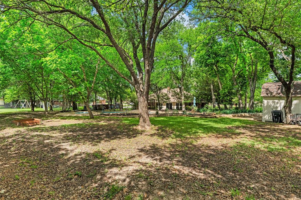 217 Valley Ranch Road Weatherford, TX 76087 - Photo 38 of 38 Expansive backyard featuring mature trees, a manicured lawn, and a visible swimming pool