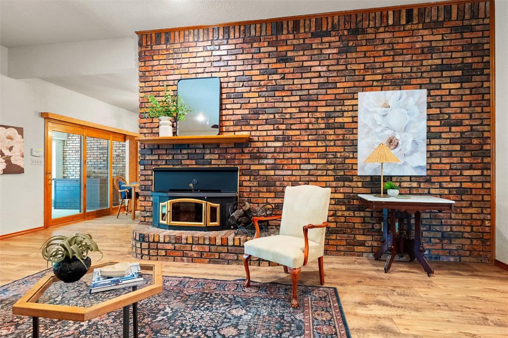 217 Valley Ranch Road Weatherford, TX 76087 - Photo 10 of 38 Brick fireplace surround with a wood-burning stove insert