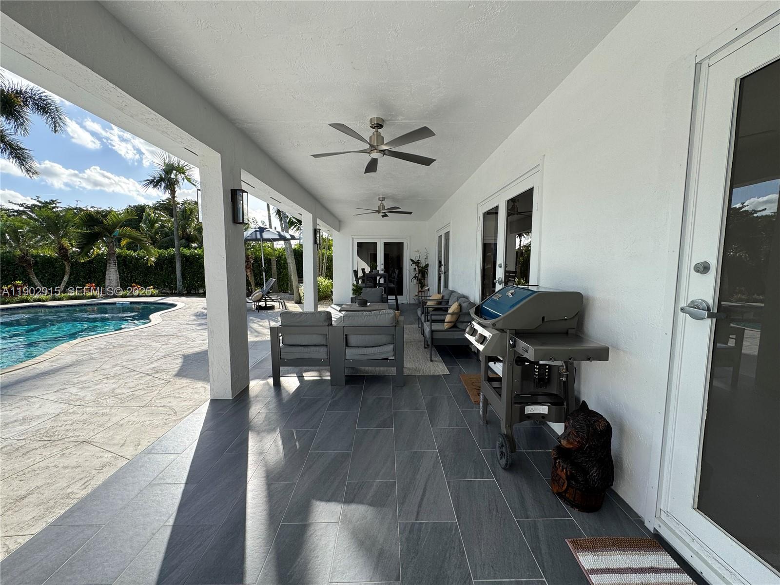20440 Southwest 292nd Street Homestead, FL 33030 - Photo 16 of 57 a living room with furniture and a large window