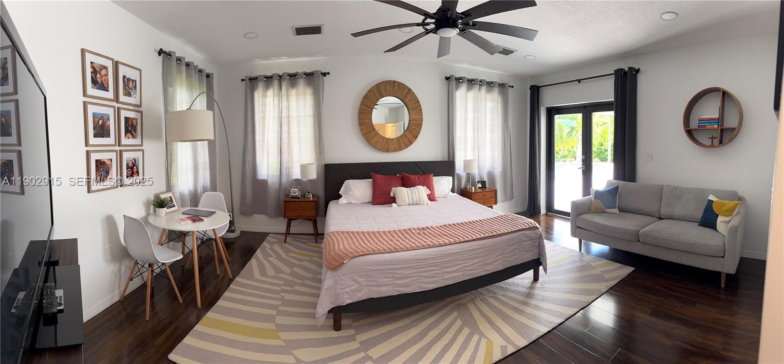 20440 Southwest 292nd Street Homestead, FL 33030 - Photo 18 of 57 a bedroom with a large bed and a chandelier