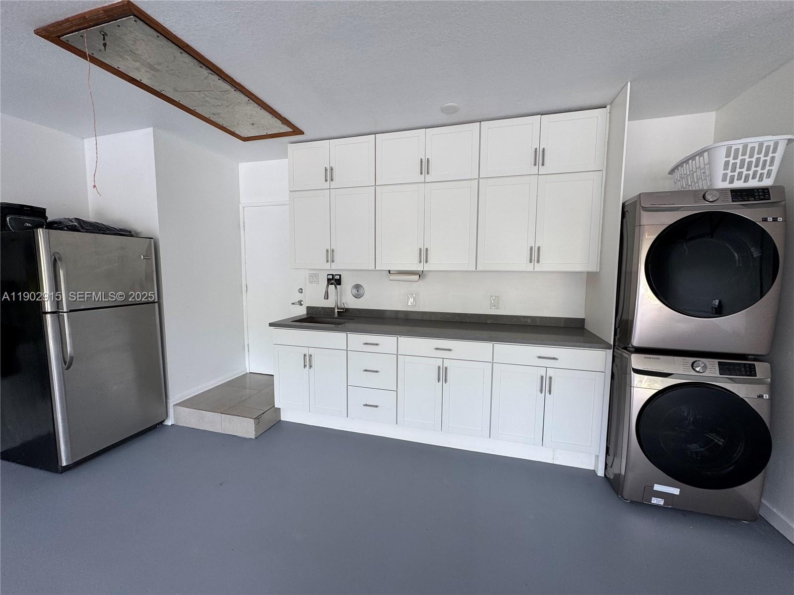 20440 Southwest 292nd Street Homestead, FL 33030 - Photo 31 of 57 a kitchen with a refrigerator and cabinets
