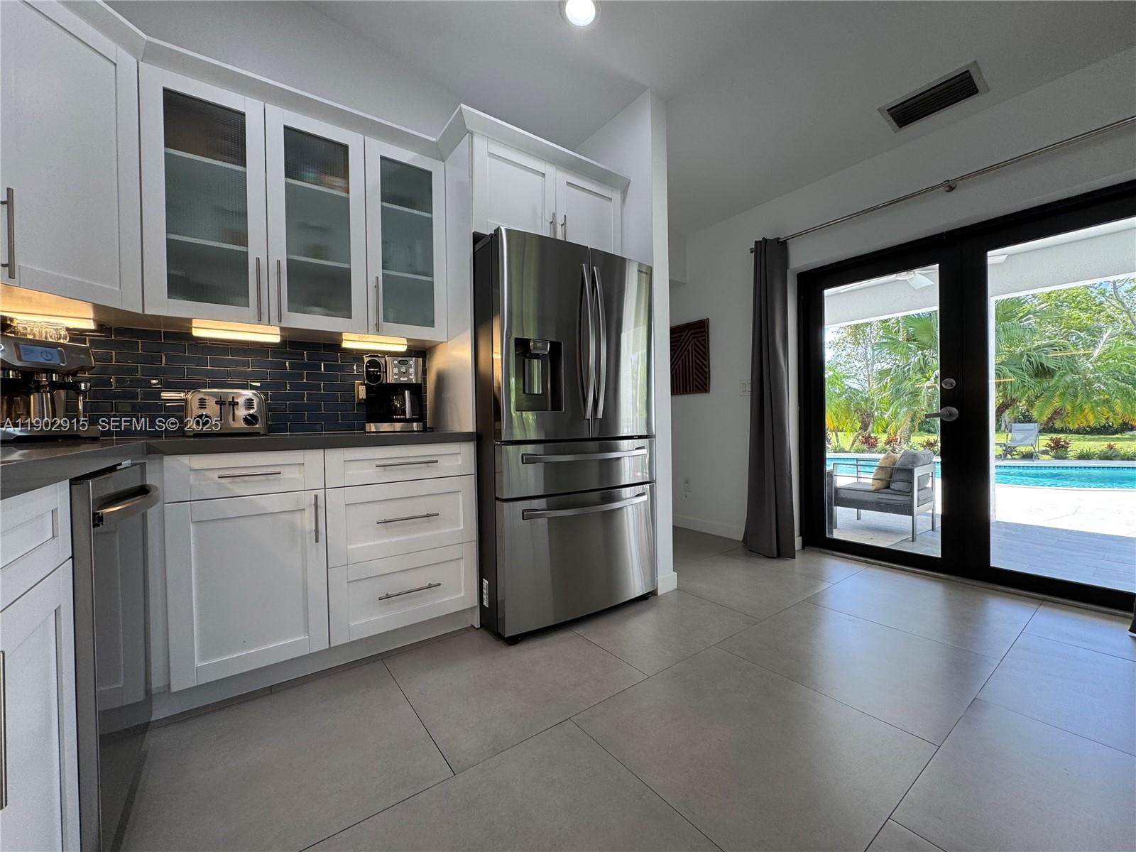 20440 Southwest 292nd Street Homestead, FL 33030 - Photo 42 of 57 a kitchen with stainless steel appliances a refrigerator sink and cabinets
