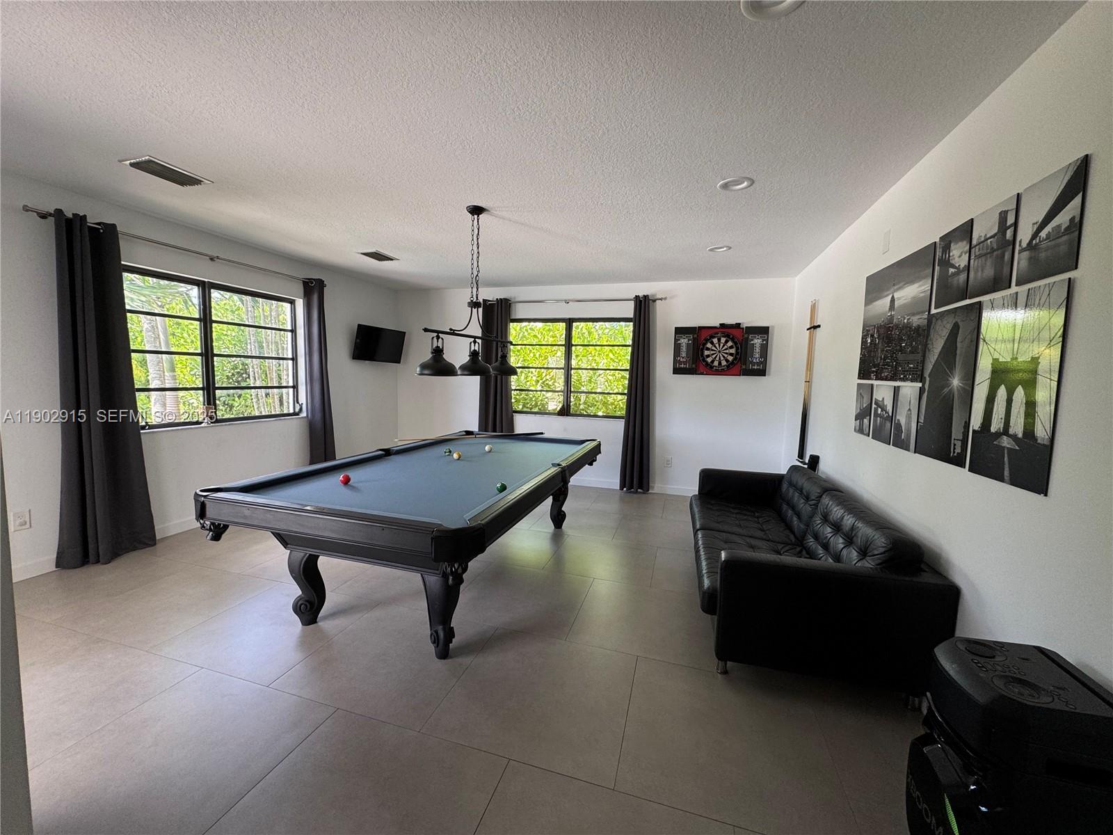 20440 Southwest 292nd Street Homestead, FL 33030 - Photo 43 of 57 a living room with furniture pool table and flat screen tv