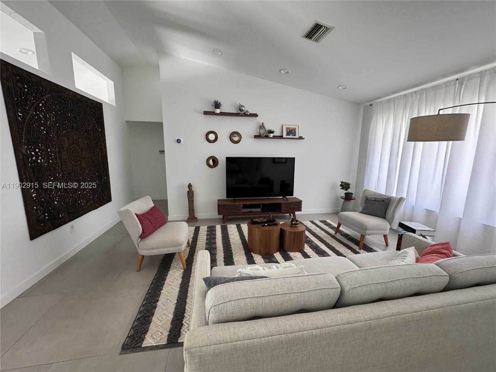 20440 Southwest 292nd Street Homestead, FL 33030 - Photo 45 of 57 a living room with furniture and a flat screen tv