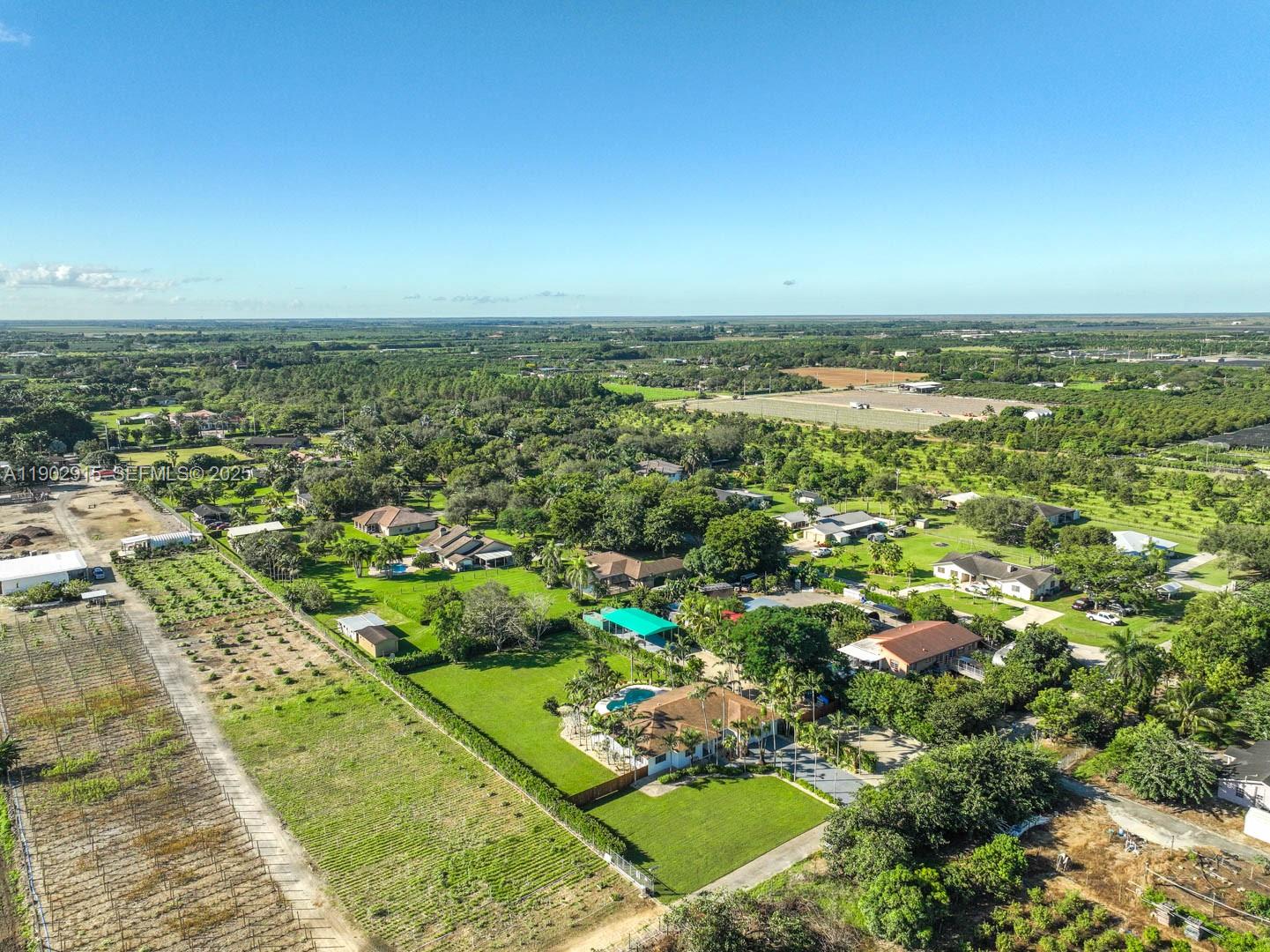 20440 Southwest 292nd Street Homestead, FL 33030 - Photo 50 of 57 an aerial view of residential houses with outdoor space and trees