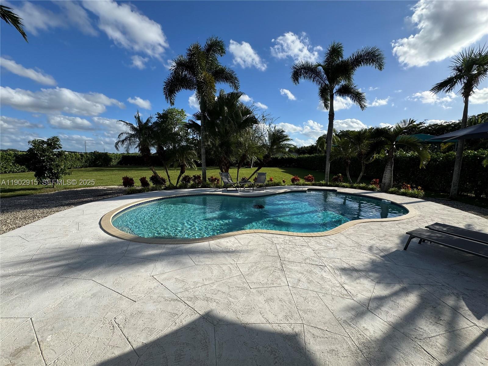 20440 Southwest 292nd Street Homestead, FL 33030 - Photo 55 of 57 a view of a swimming pool with a yard