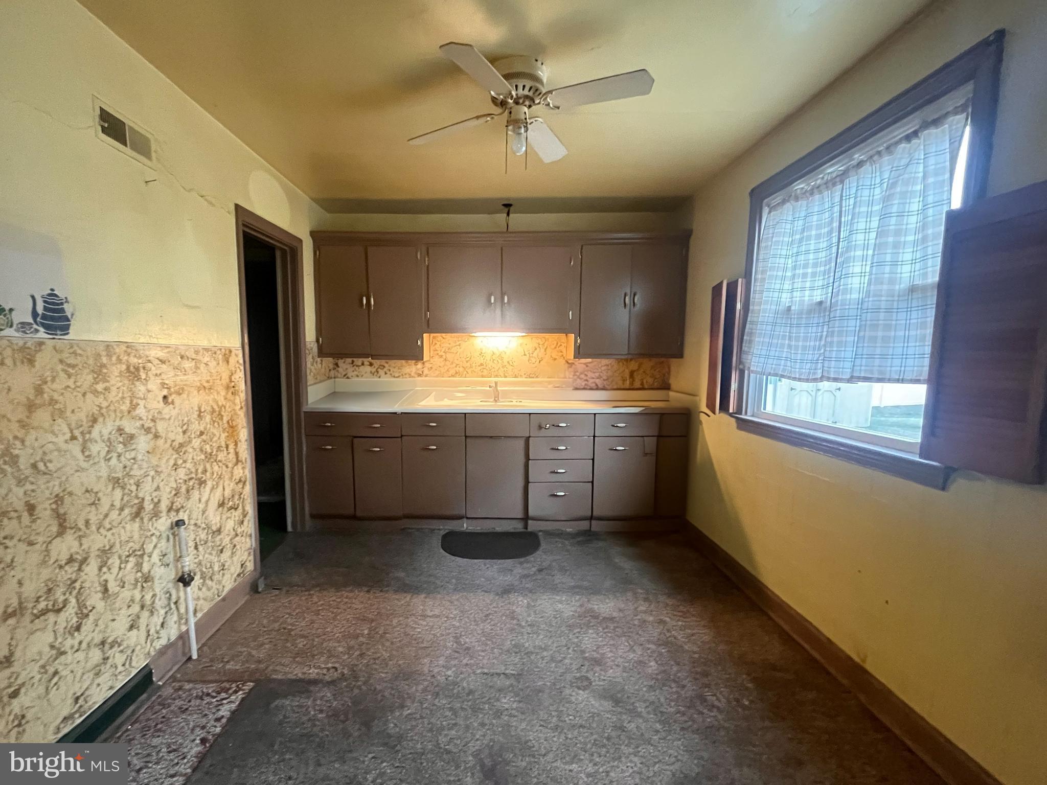 105 Harding Avenue Wilmington, DE 19804 - Photo 5 of 16 a kitchen with granite countertop a sink window and cabinets