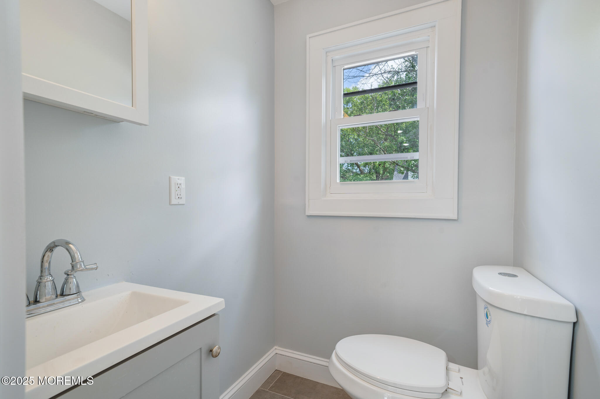 101 Broad Street Matawan, NJ 07747 - Photo 12 of 44 a bathroom with a toilet a sink a mirror and a window