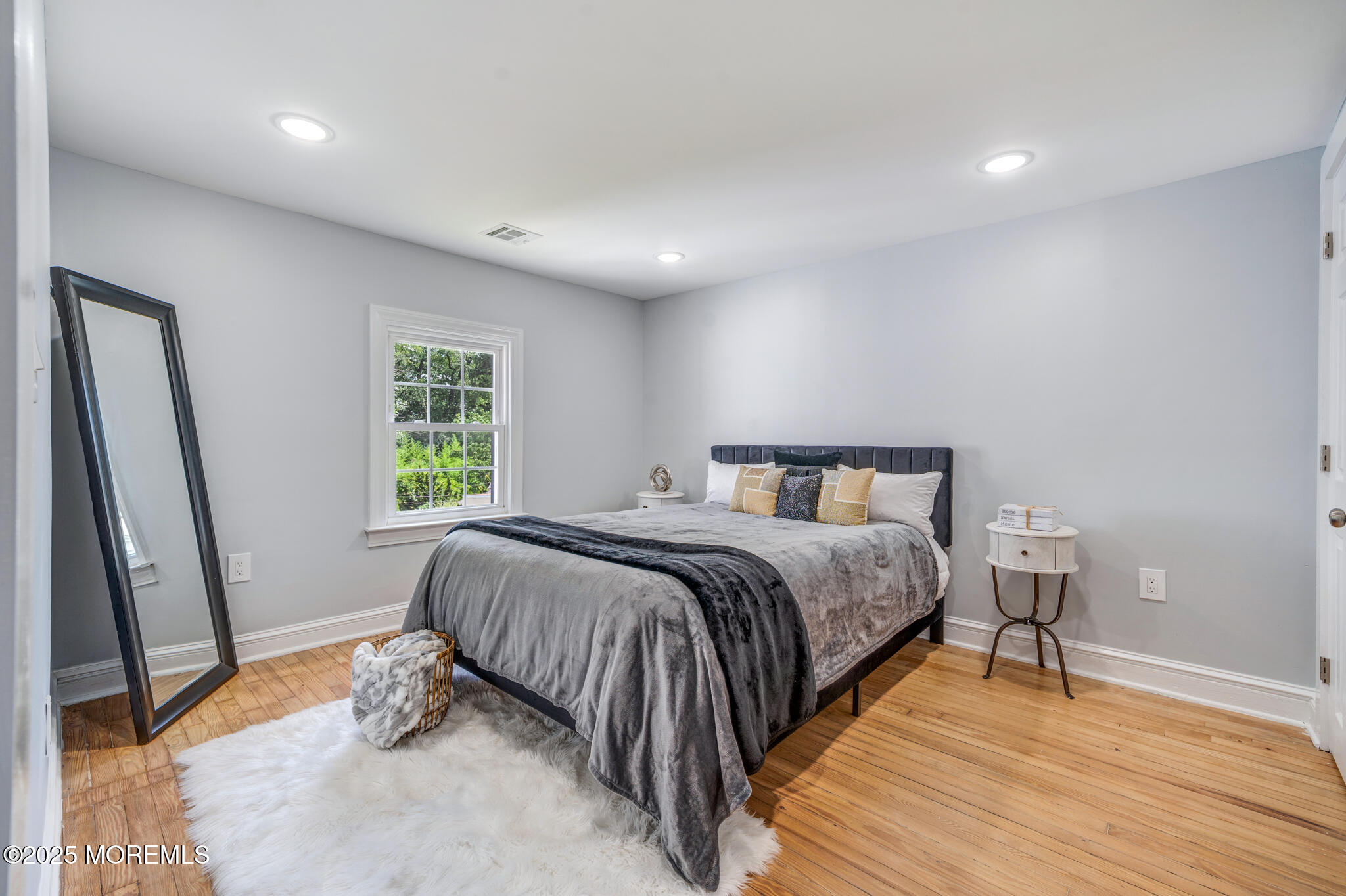 101 Broad Street Matawan, NJ 07747 - Photo 15 of 44 a bed sitting in a spacious bedroom next to a window