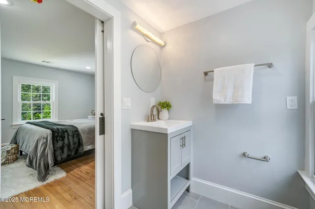 a bedroom with a bed and a mirror