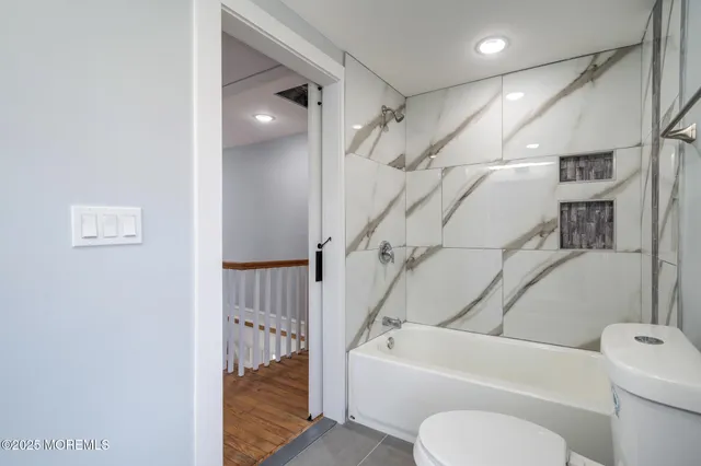 a bathroom with a toilet a sink and bathtub