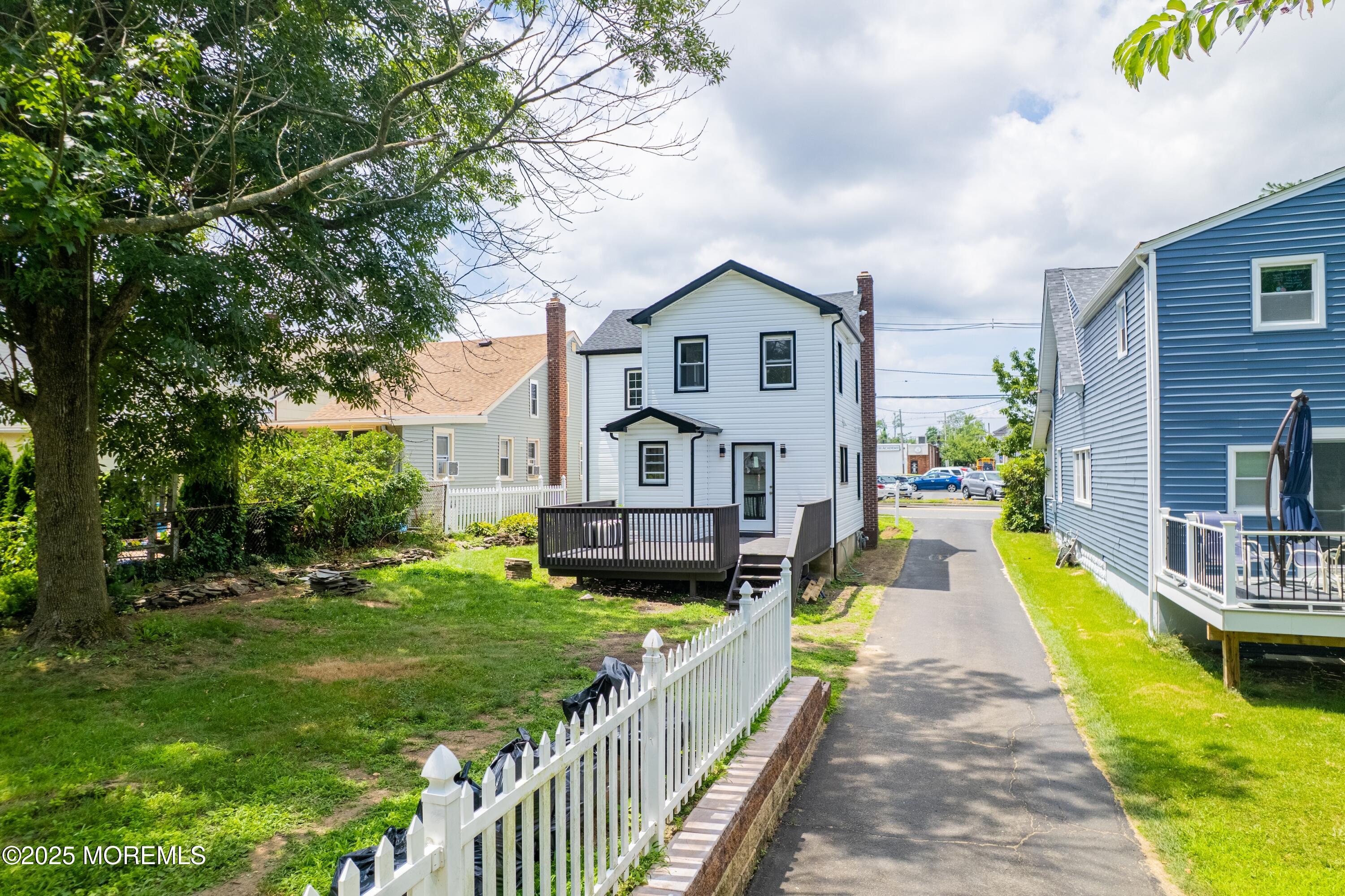 101 Broad Street Matawan, NJ 07747 - Photo 31 of 44 a view of a house with a big yard potted plants and large tree