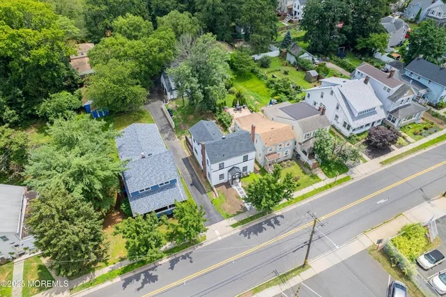 an aerial view of a house with garden space and street view