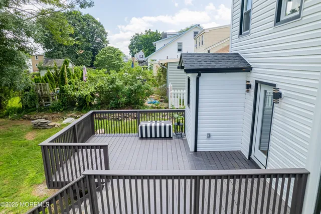 a view of a roof deck with wooden fence and plants