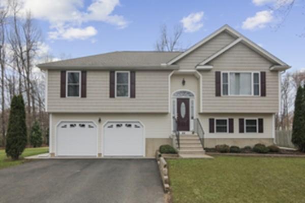 44 Steele Road Enfield, CT 06082 - Photo 1 of 18 a view of a white house with a big yard and large trees
