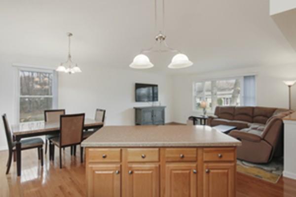 44 Steele Road Enfield, CT 06082 - Photo 8 of 18 a view of a dining room with furniture and wooden floor