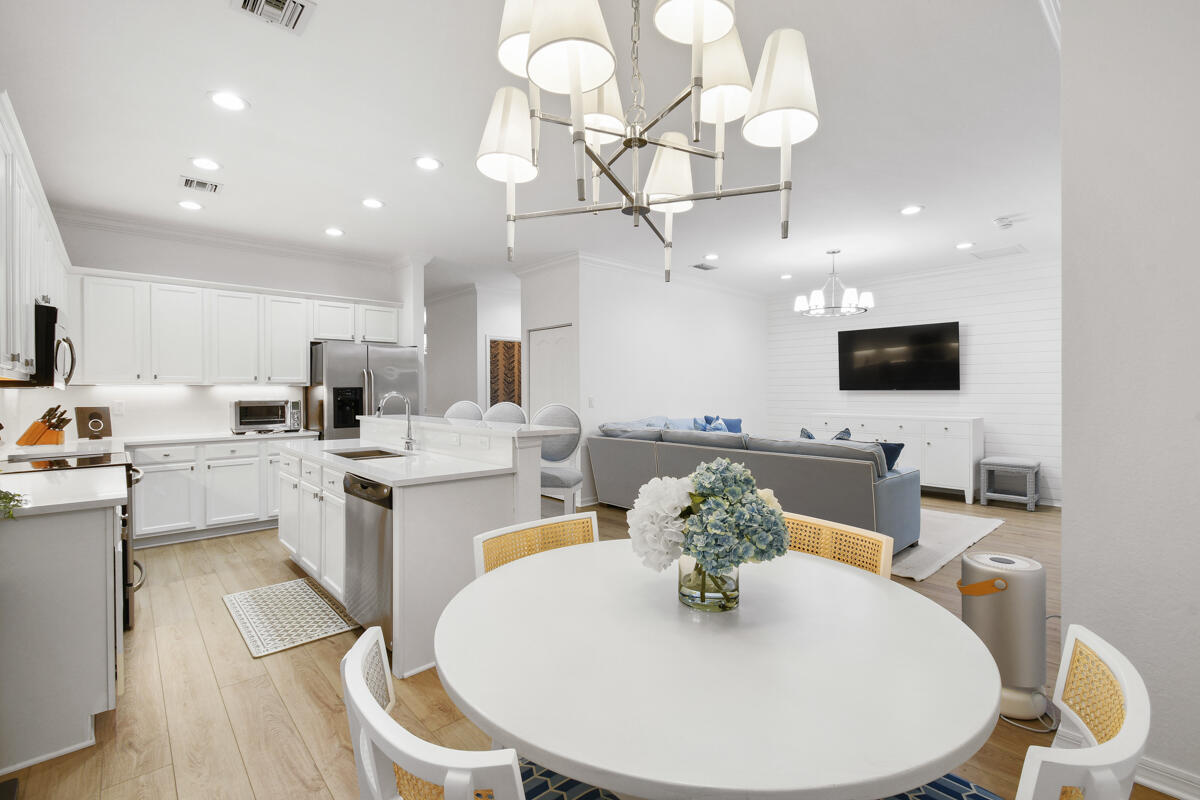 193 Porgee Rock Place Jupiter, FL 33458 - Photo 15 of 76 a kitchen with stainless steel appliances kitchen island granite countertop a sink a microwave a dining table and chairs