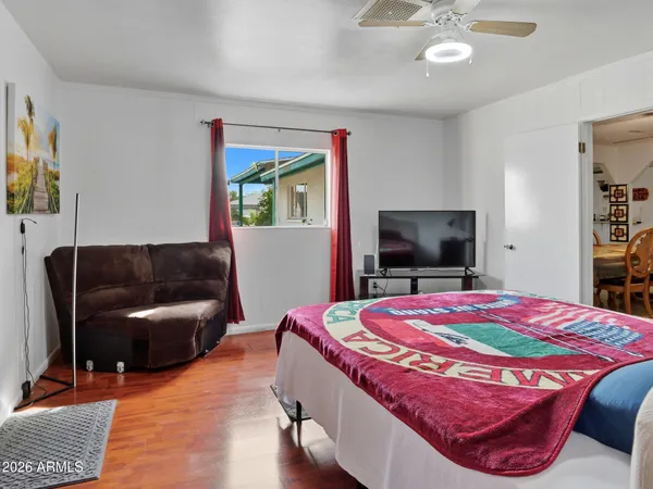 a bedroom with a bed and a flat screen television