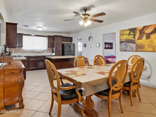 a dining table with chairs and window