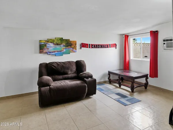 a living room with furniture and a rug