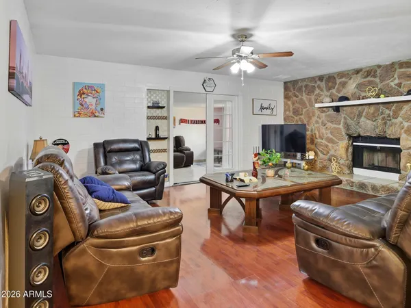 a living room with furniture a fireplace and a chandelier