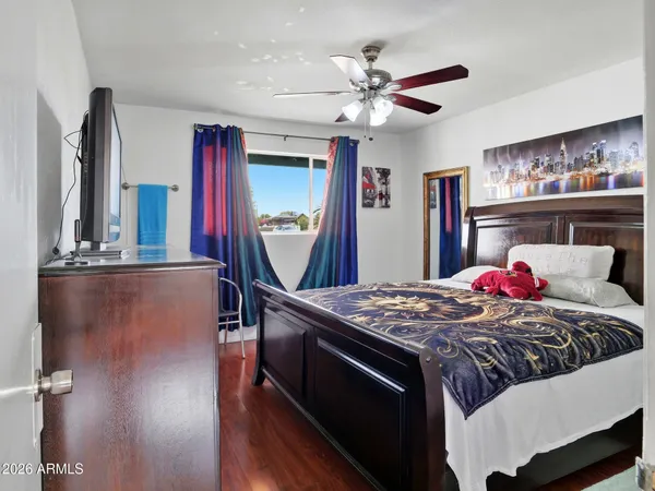 a bedroom with bed and a chandelier