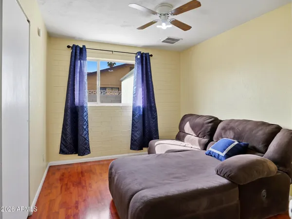 a bedroom with a bed and wooden floor